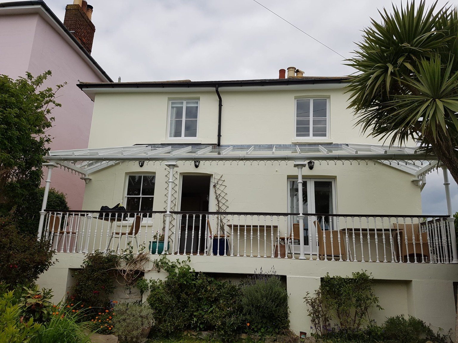 Finished cream house with veranda and garden
