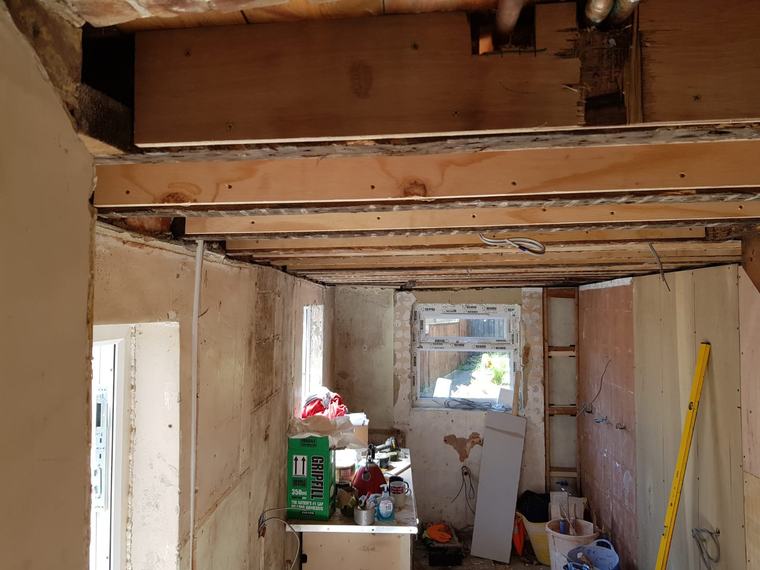 Room refurbishment in progress with exposed ceiling joists