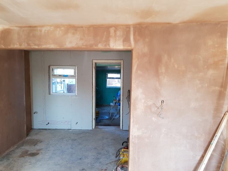 Interior room with fresh plaster and boarded wall