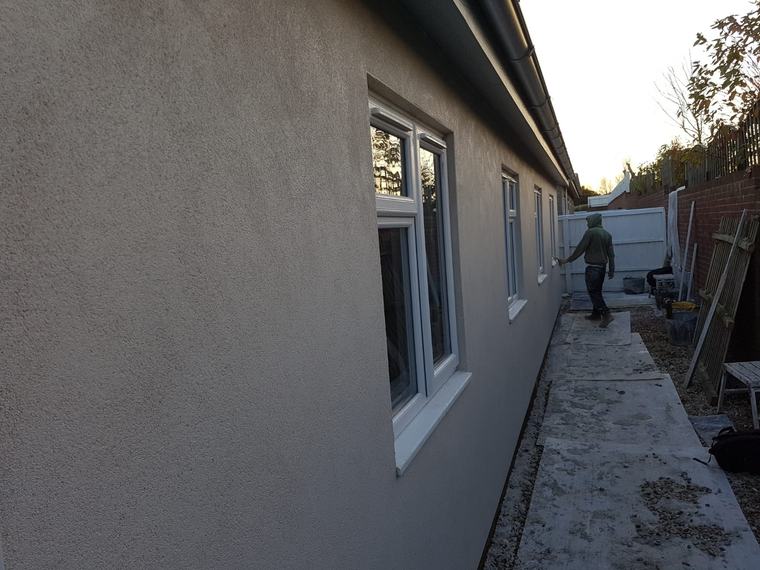 Finished rendered side wall with windows