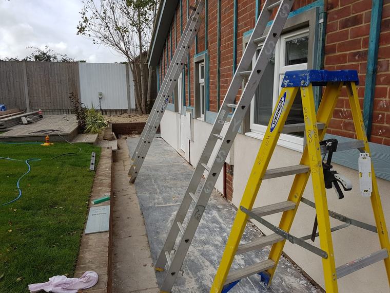 Exterior preparation with ladders before cladding and render