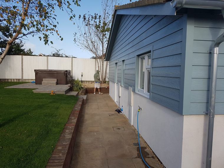 Finished blue cladding exterior beside lawn and path