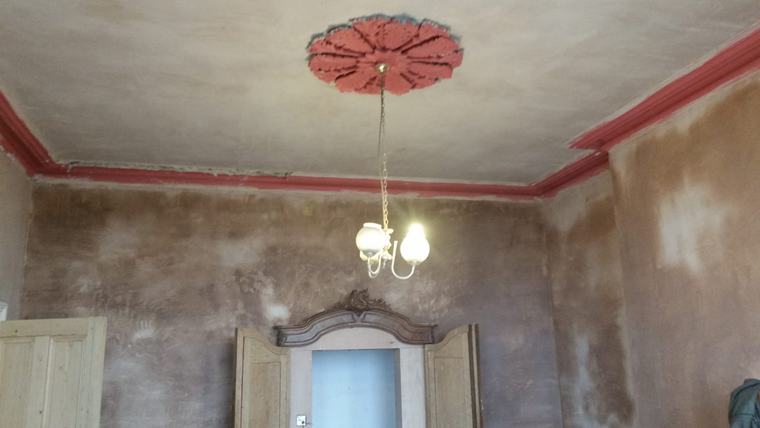 Period room with ceiling rose and plastering in progress