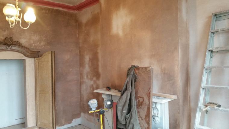 Period interior room with plastering and fireplace detail