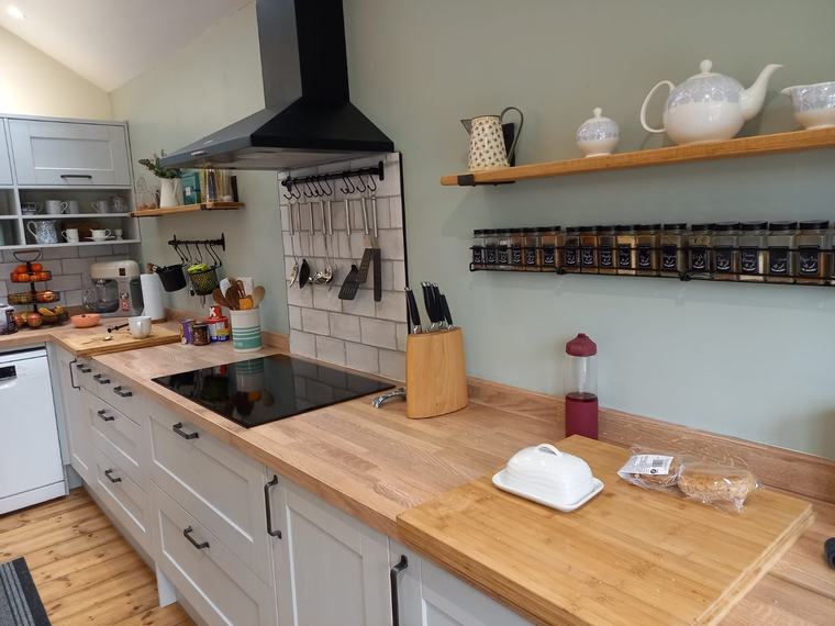 Finished kitchen renovation with grey units and timber worktops