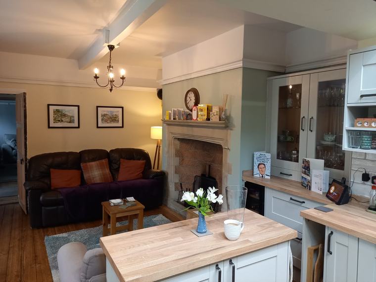 Open kitchen and living area with fireplace after renovation