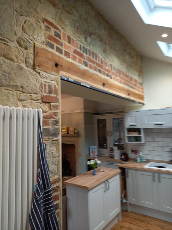 Kitchen renovation with exposed stone and brick feature wall